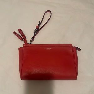 Coach Women’s crimson colored clutch with tassels